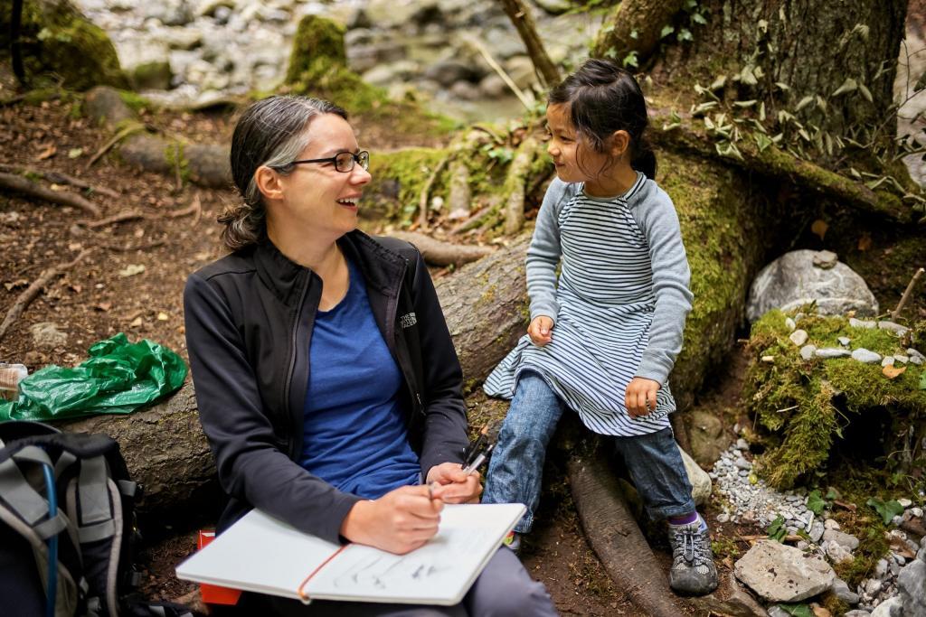 Jen and her duaghter laughing together while reading.