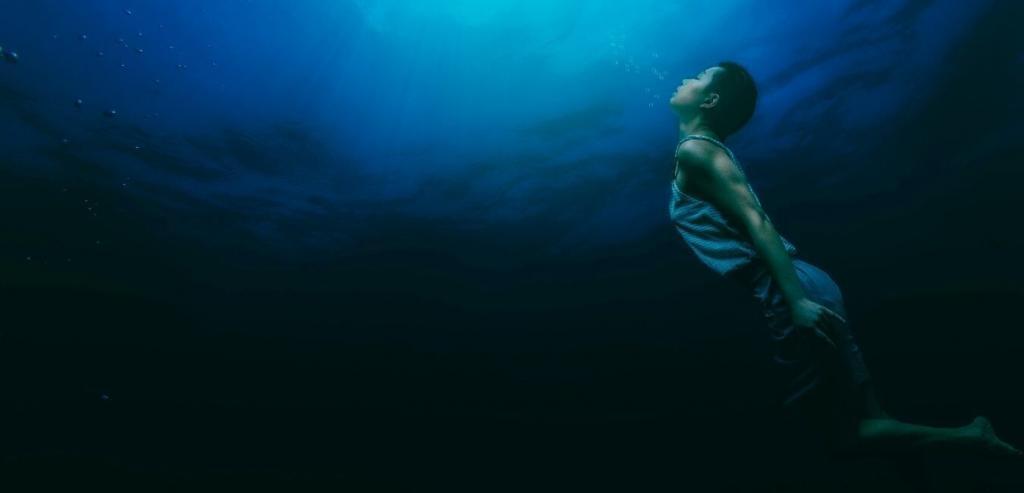 Woman floating underwater
